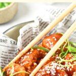 Chopsticks on top of a bowl of korean fried chicken
