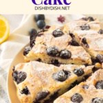 A sliced gluten-free lemon blueberry cake sprinkled with powdered sugar.