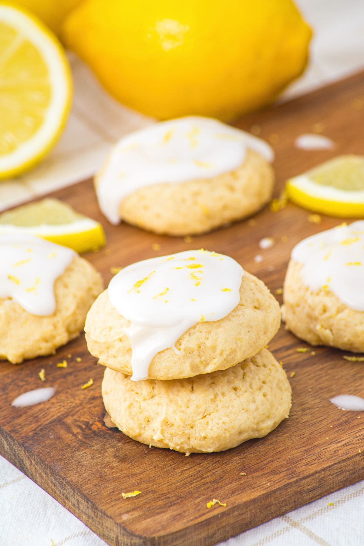 A stack of lemon ricotta cookies on wooden board