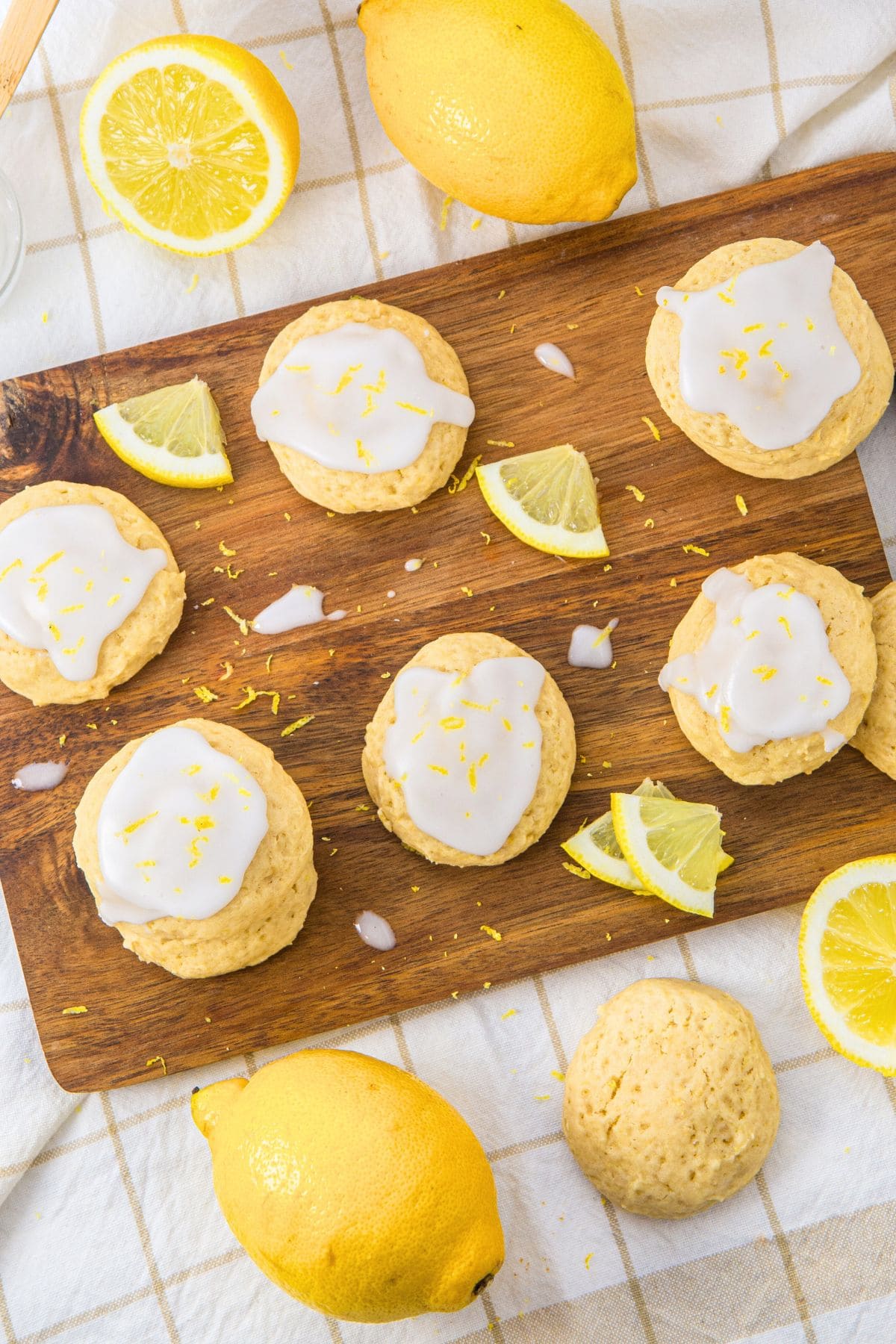 Top down view of lemon and ricotta cookies on wooden board.