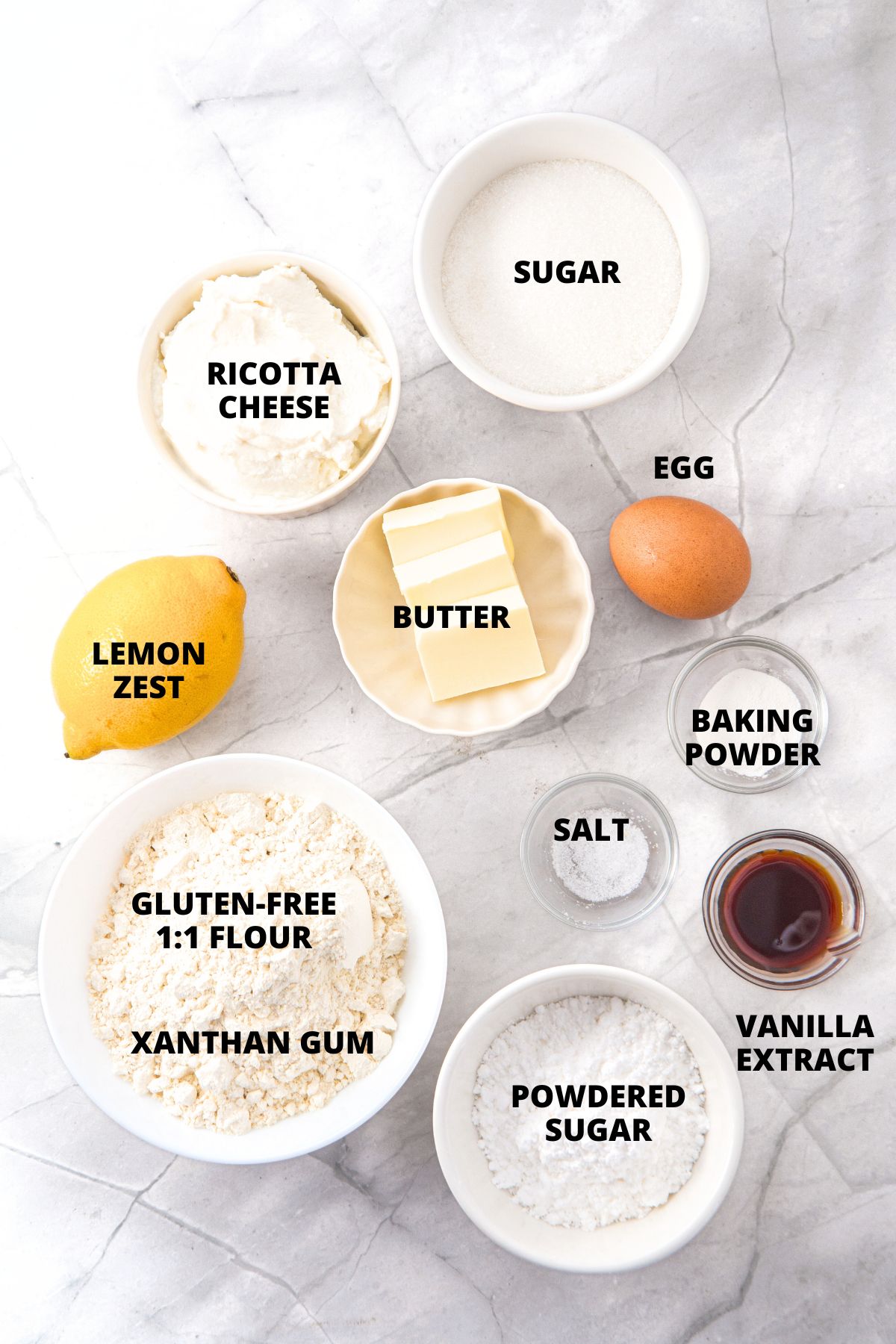 Ingredients for lemon ricotta cookies recipe laid out on board.
