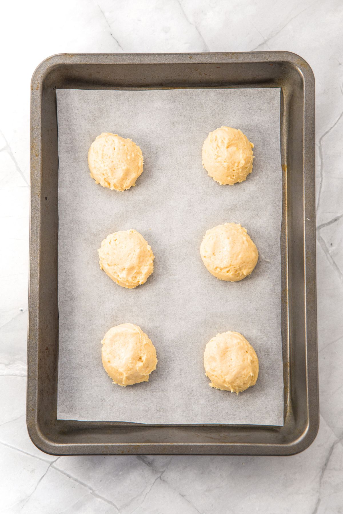 Cookie dough balls on parchment