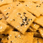 Up close view of lentil crackers topped with sesame seeds
