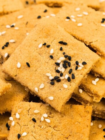 Up close view of lentil crackers topped with sesame seeds