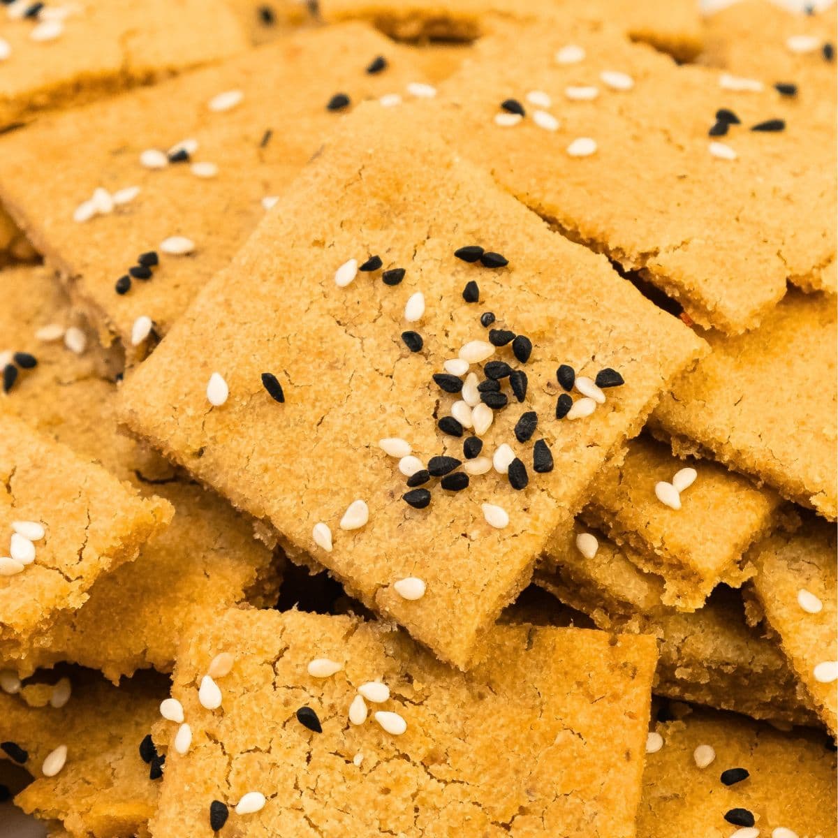 Up close view of lentil crackers topped with sesame seeds