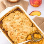 A baking dish with half-eaten almond flour peach cobbler.
