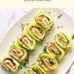 A plate full of salmon and cucumber rollups