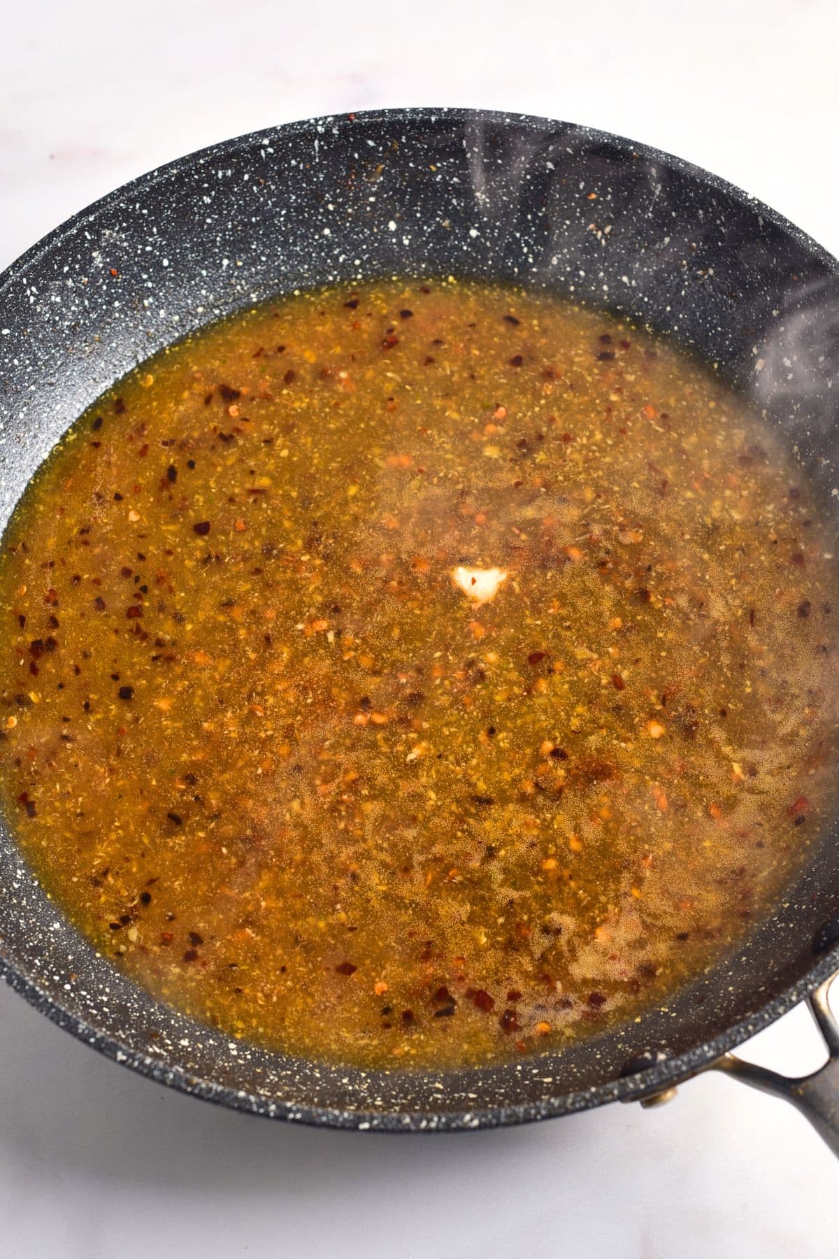 Cooking chicken broth in skillet