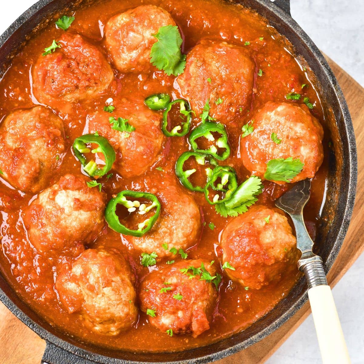 A skillet full of Mexican chicken meatballs