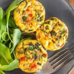 Top down view of mini crustless quiches on plate
