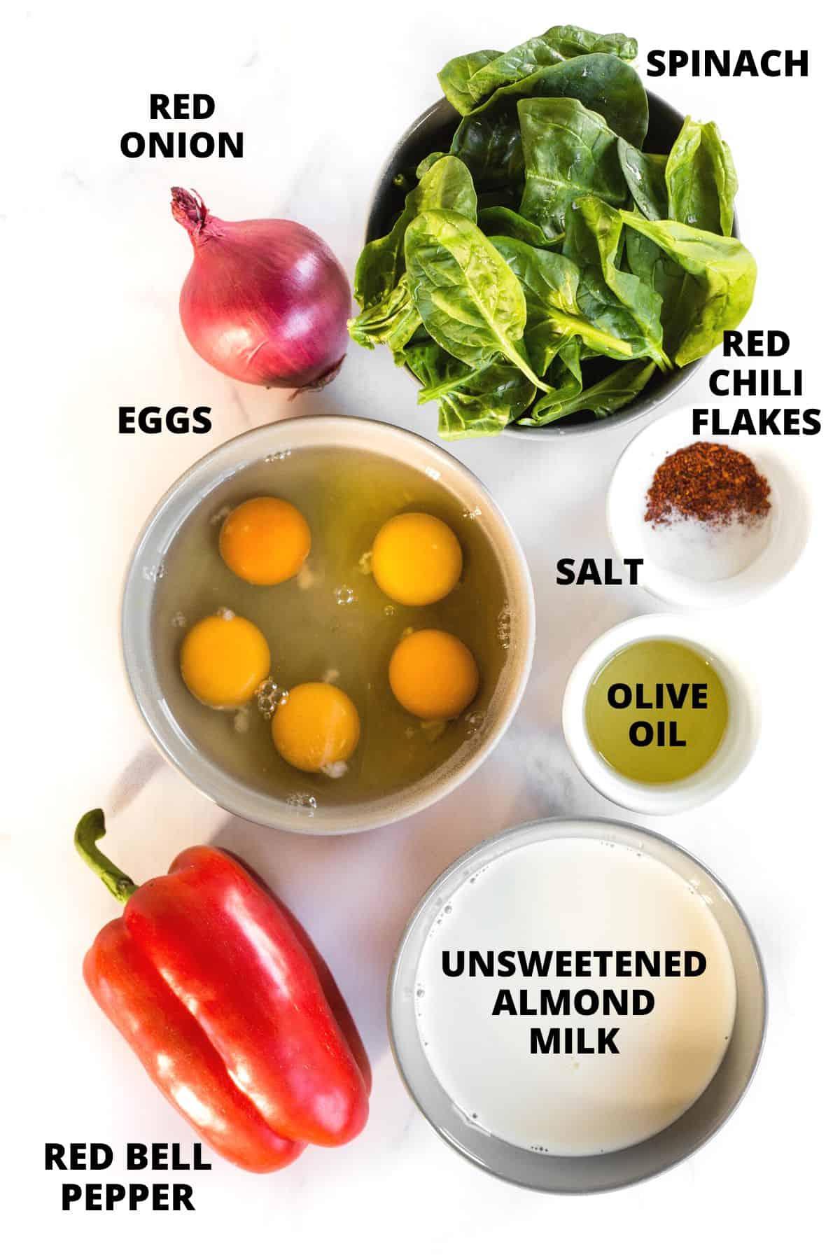 Ingredients for mini crustless quiche recipe laid out on a marble board.