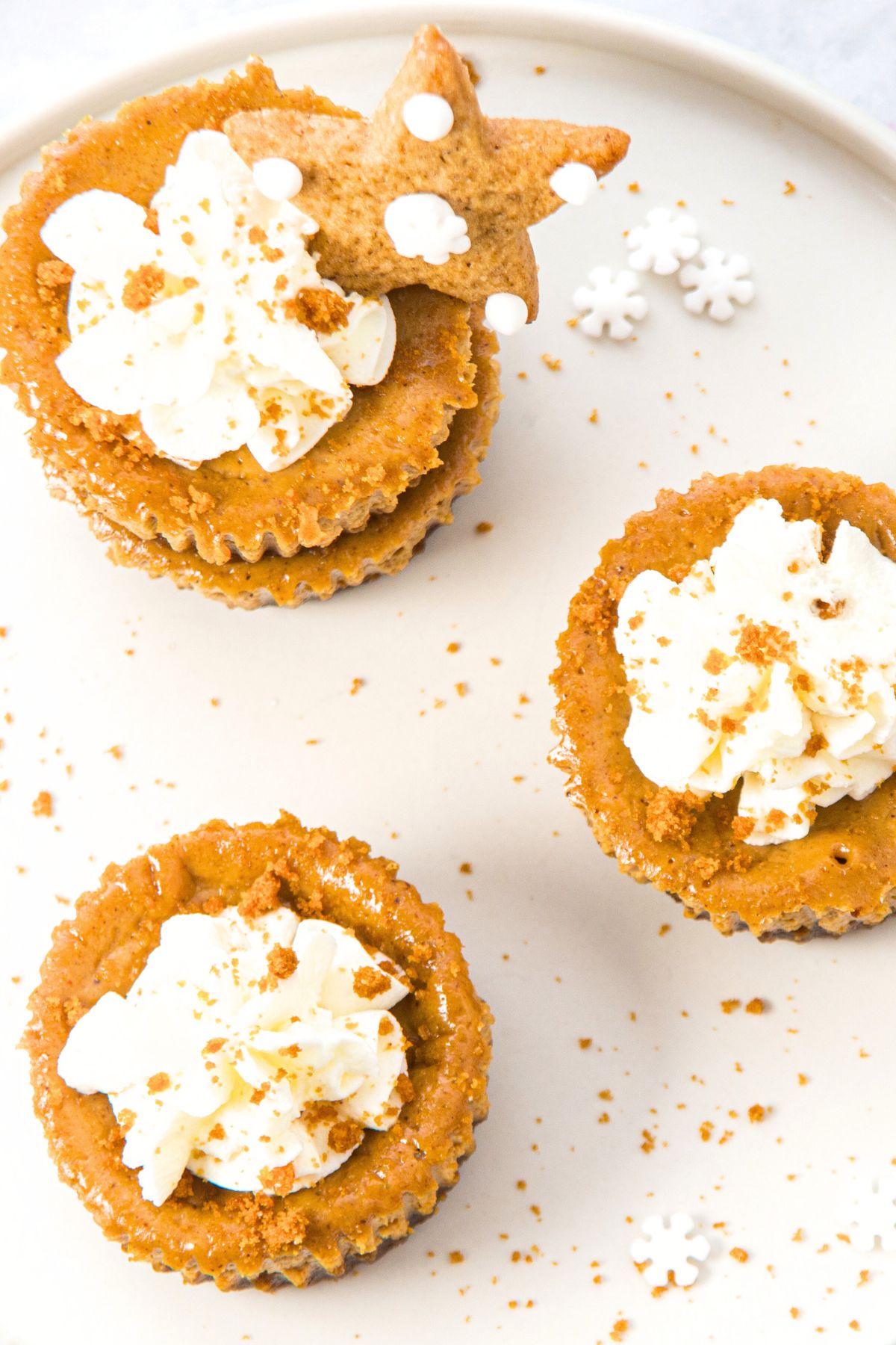 Top down view of gingerbread mini cheesecakes on white plate