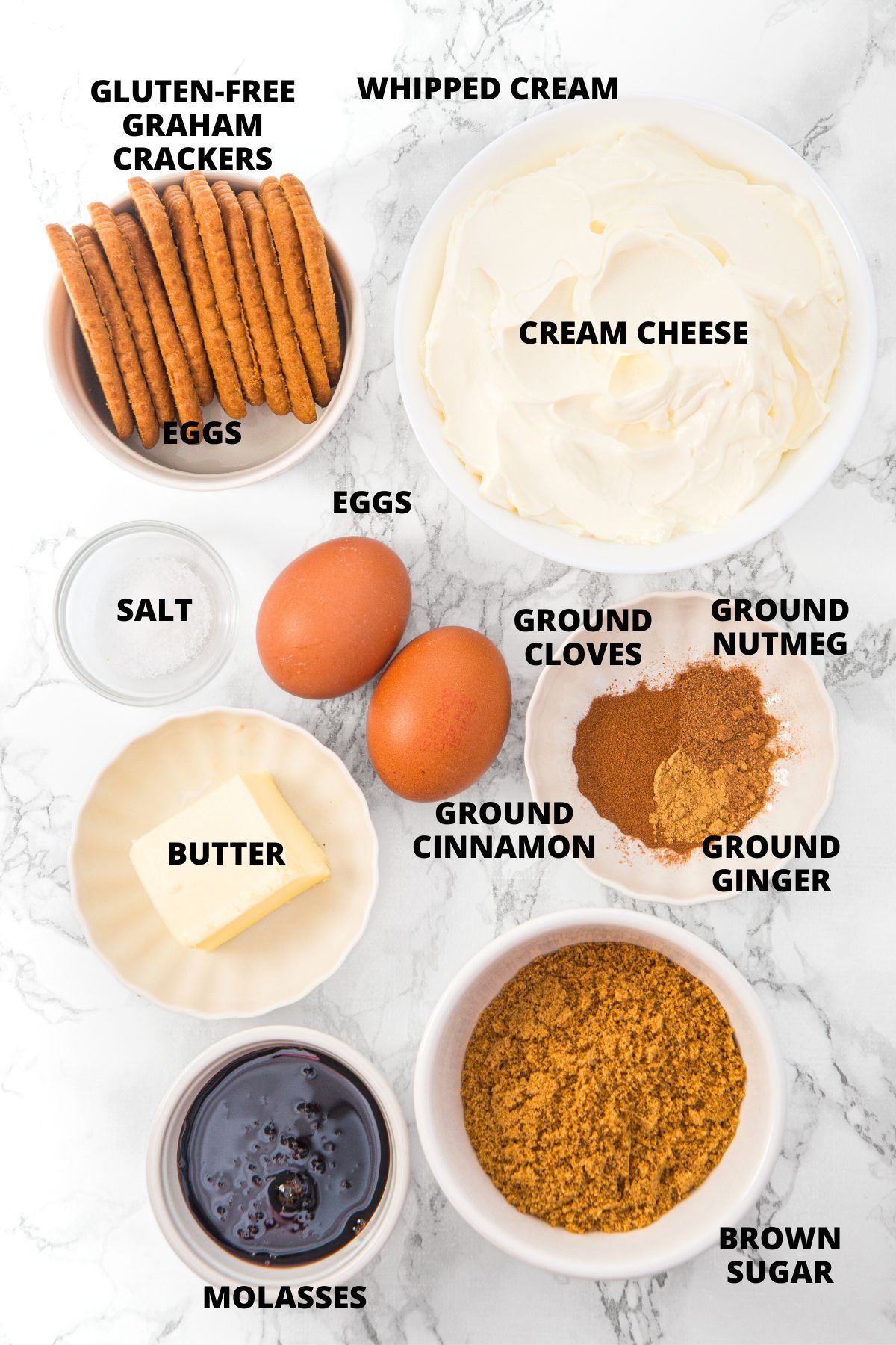 Ingredients for mini gingerbread cheesecakes recipe laid out on marble board