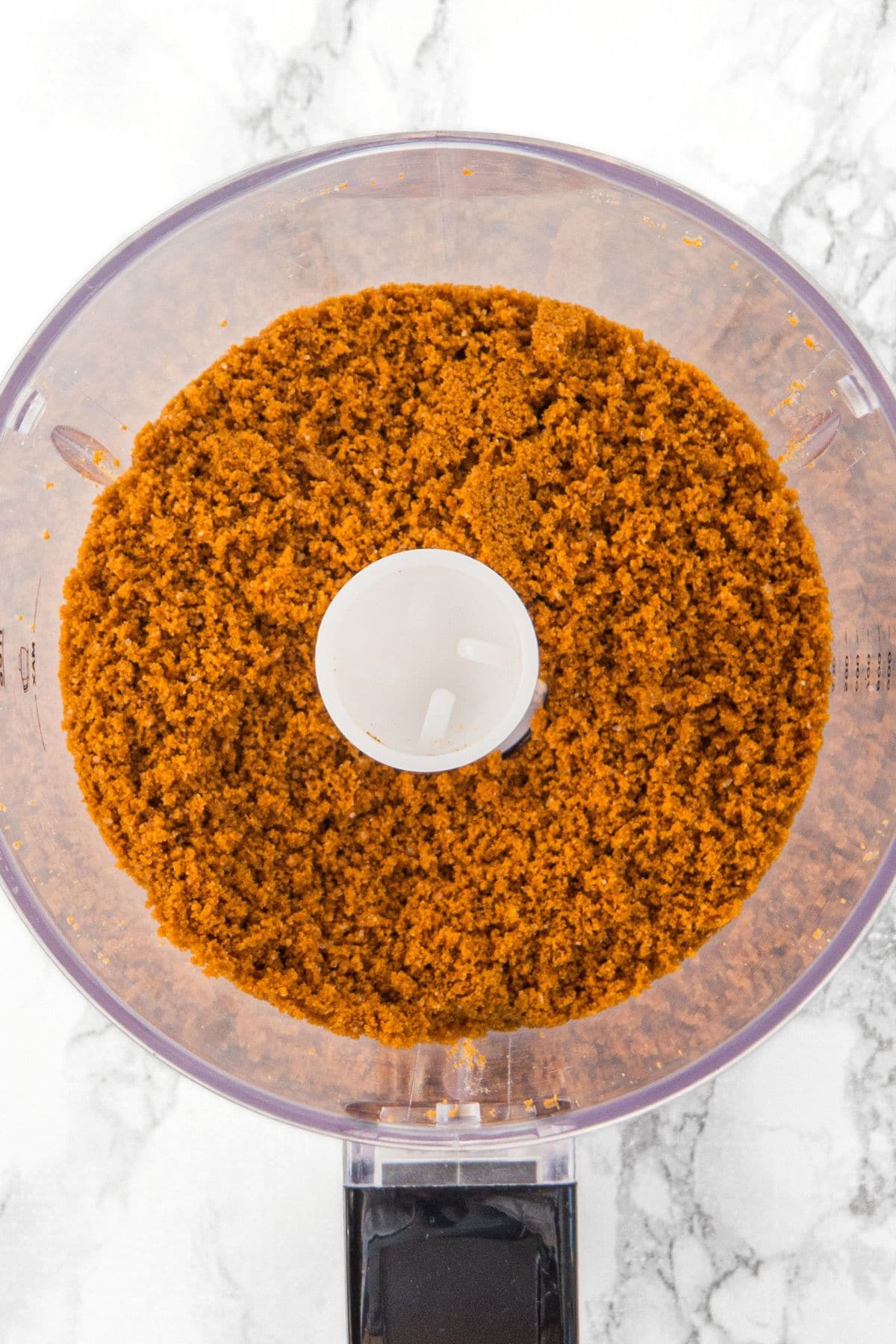 Processed graham cracker crumbs in food processor.