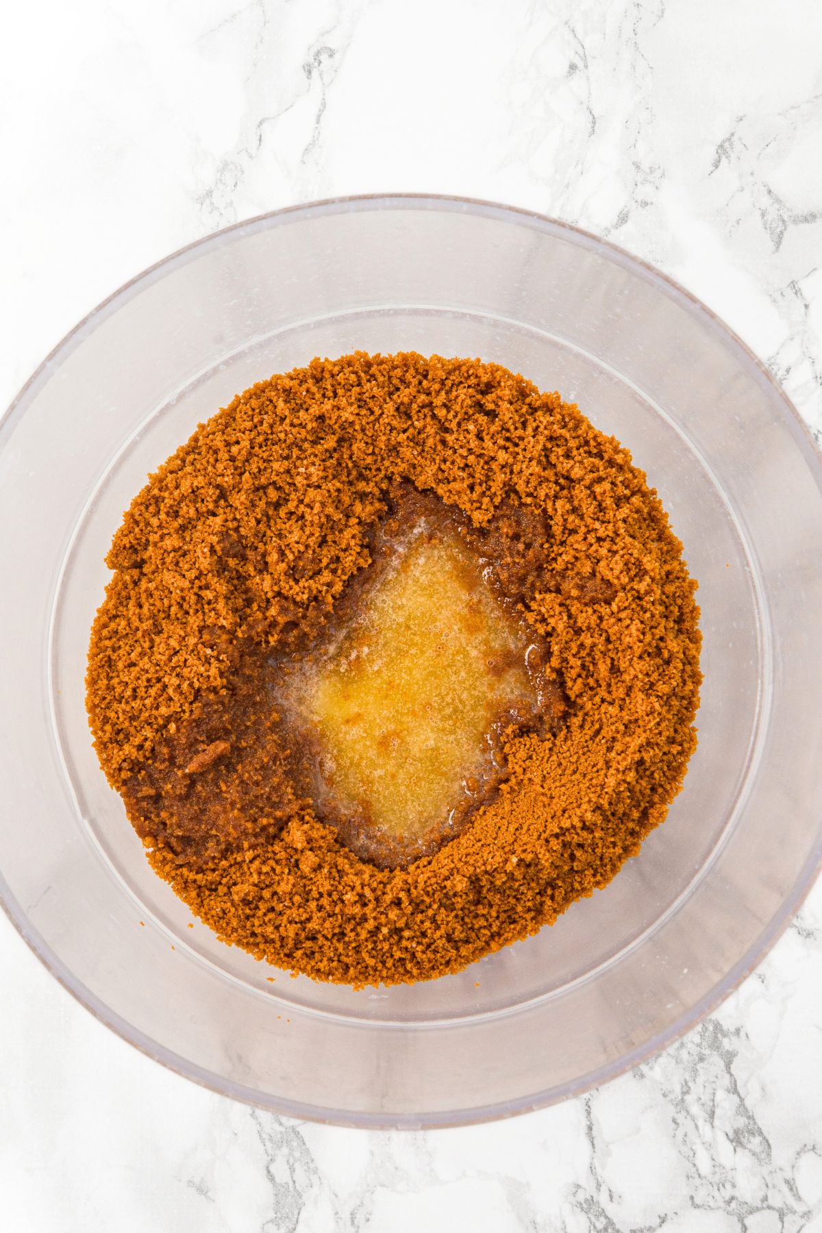 Graham crackers crumbs and melted butter in bowl