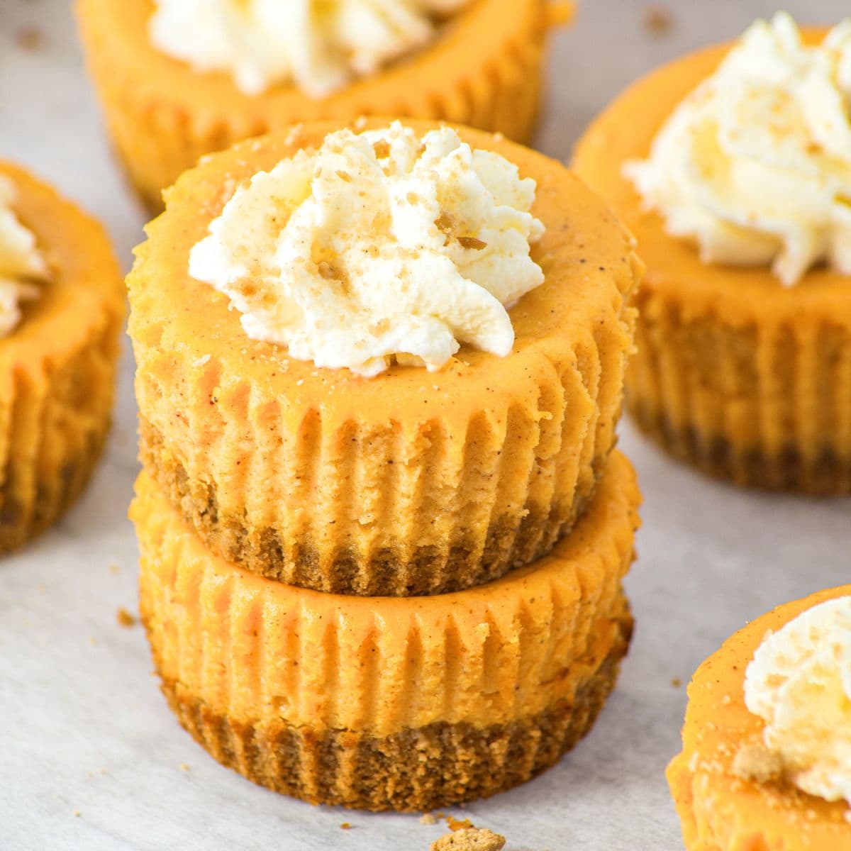Mini pumpkin cheesecakes stacked on top of each other