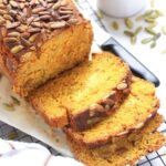 Sliced loaf of pumpkin bread on wire rack