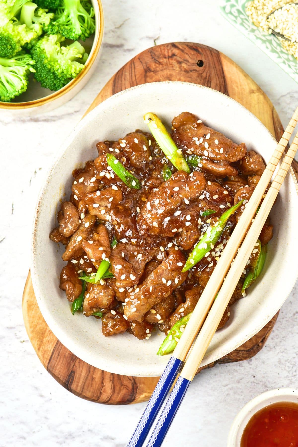 A bowl of gluten-free Mongolian beef sprinkled with sesame seeds