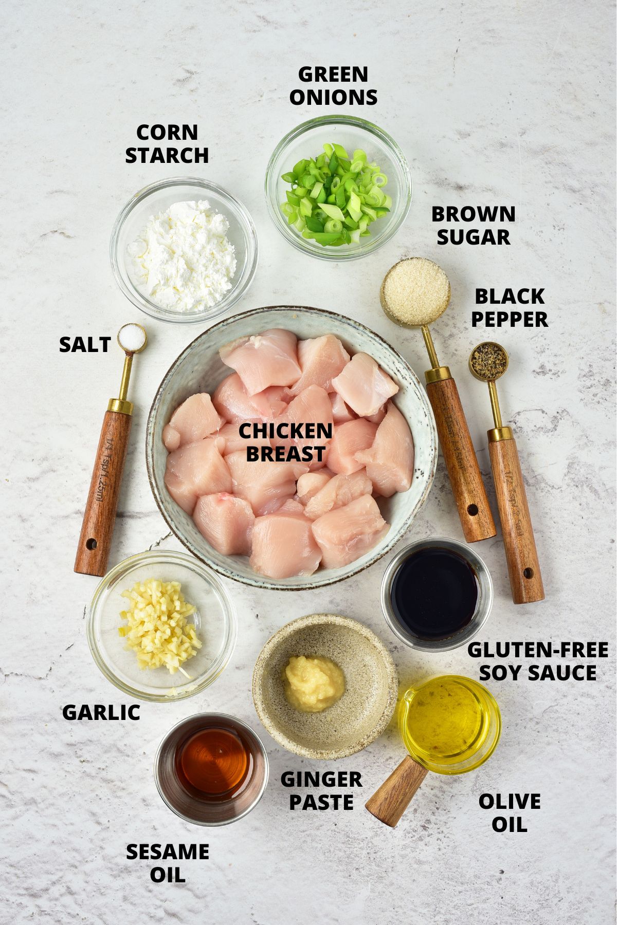 Top down view of ingredients for Mongolian chicken recipe laid out on marble board.
