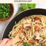 Mixing vegan aglio olio in a skillet