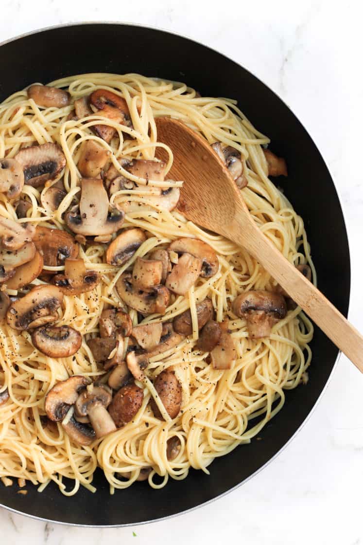 A skillet with mushroom spaghetti aglio olio.