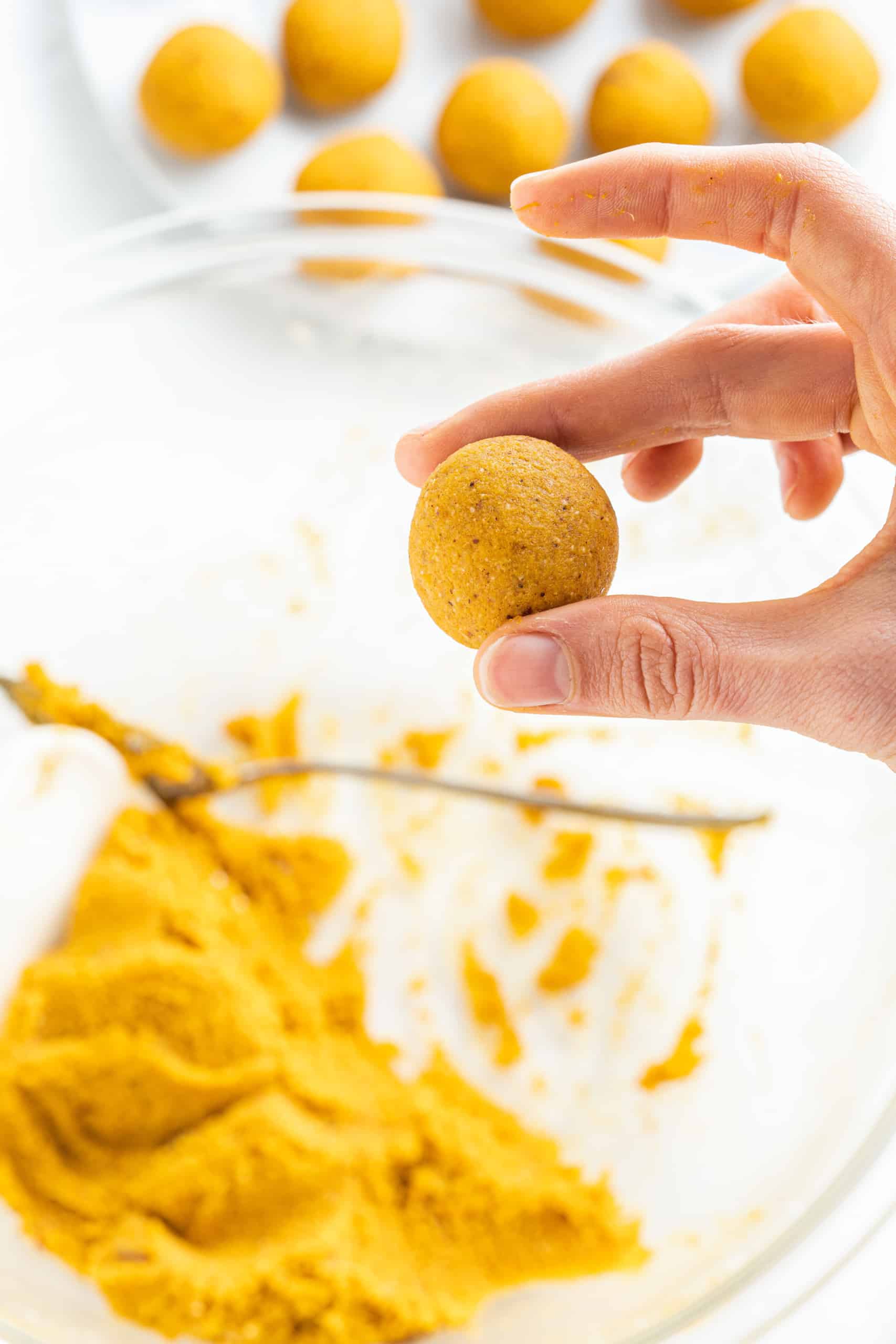 Rolling pumpkin truffle dough into balls.