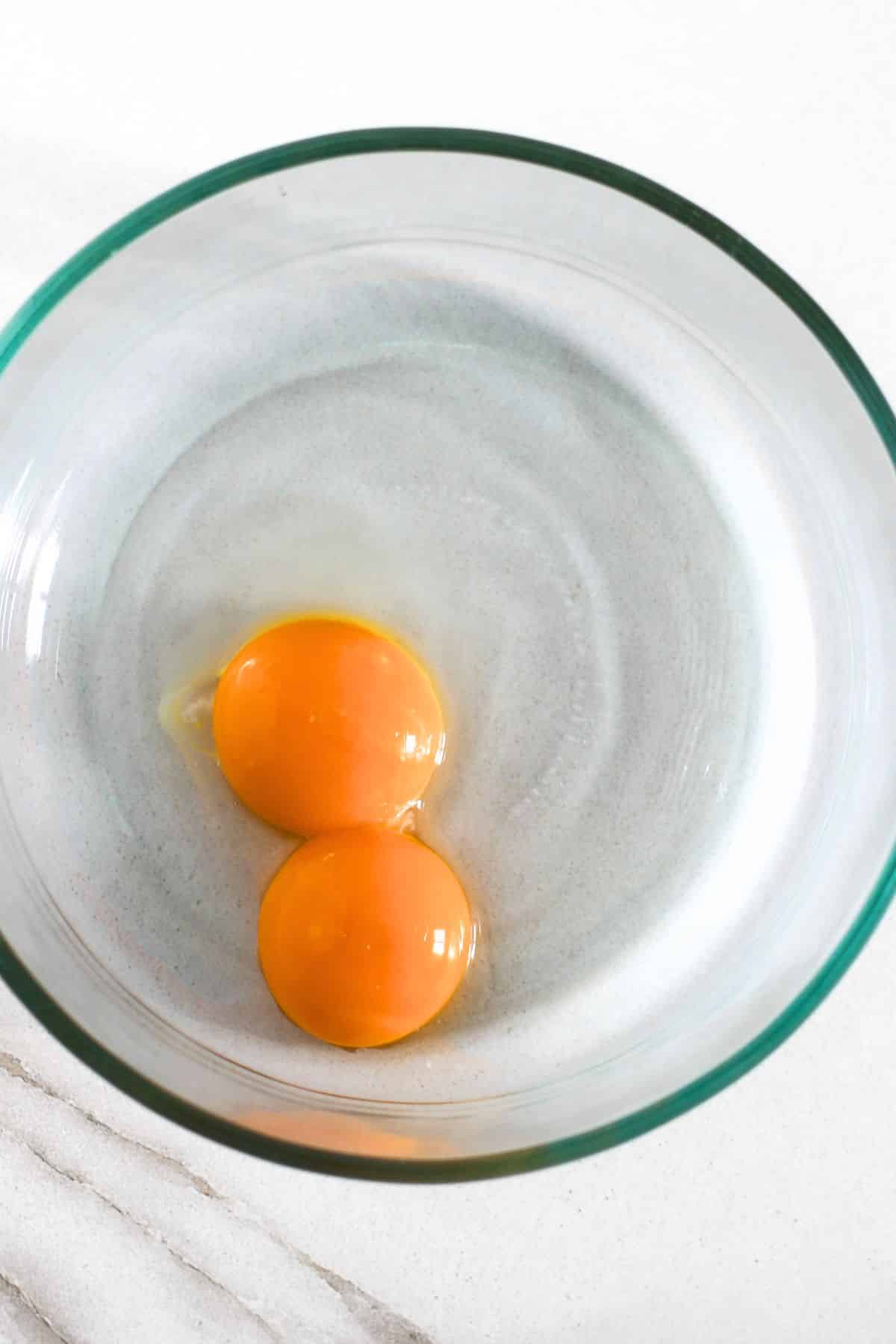 Egg yolks in glass bowl.