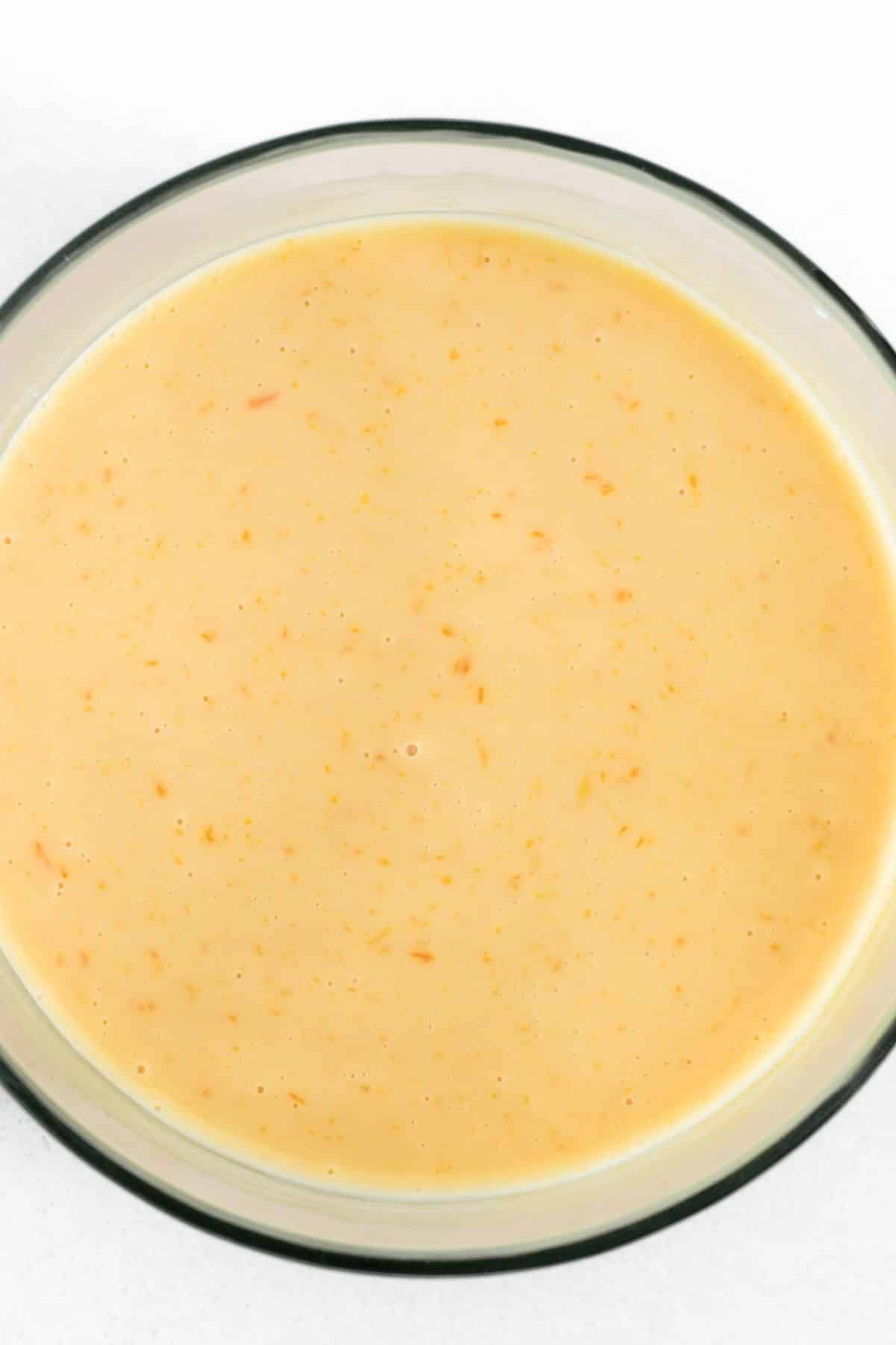 Condensed milk mixture in glass bowl.