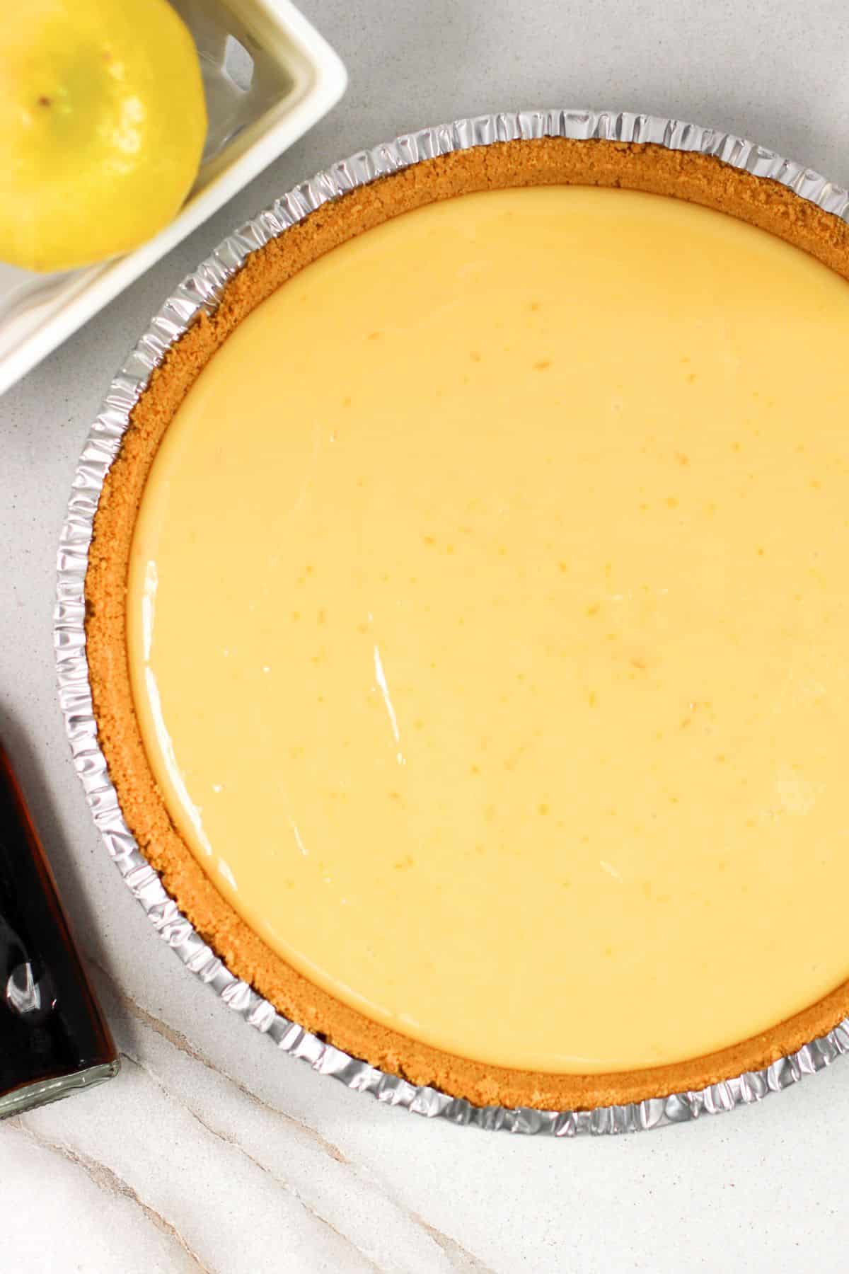 Top down view of lemon filling mixture in graham cracker crust.