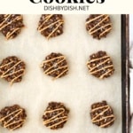 No bake cookies drizzled in peanut butter on parchment-lined sheet.