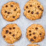 Top down view of chocolate chip almond flour oatmeal cookies on parchment paper.