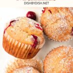 Top down view of cranberry muffins on white plate.