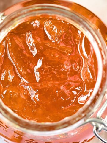 Top down view of jar of homemade orange marmalade.
