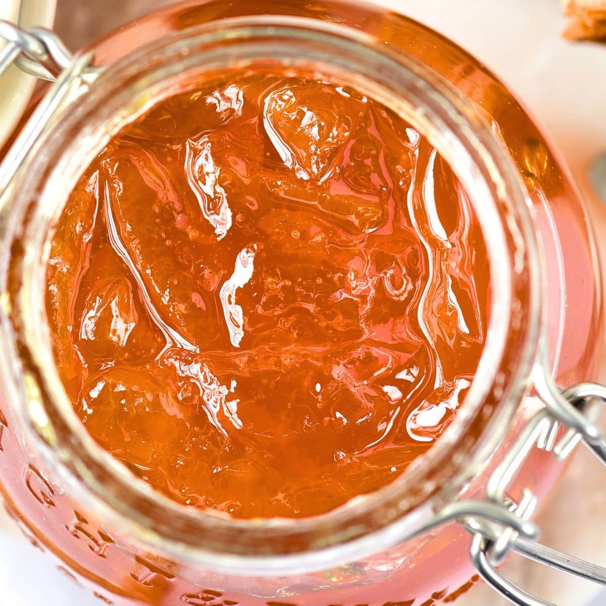 Top down view of jar of homemade orange marmalade.