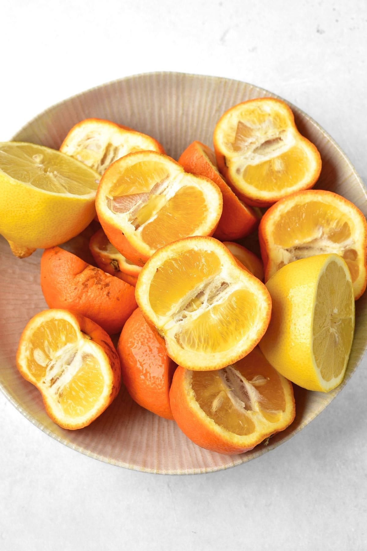 Halved oranges and lemons in a bowl