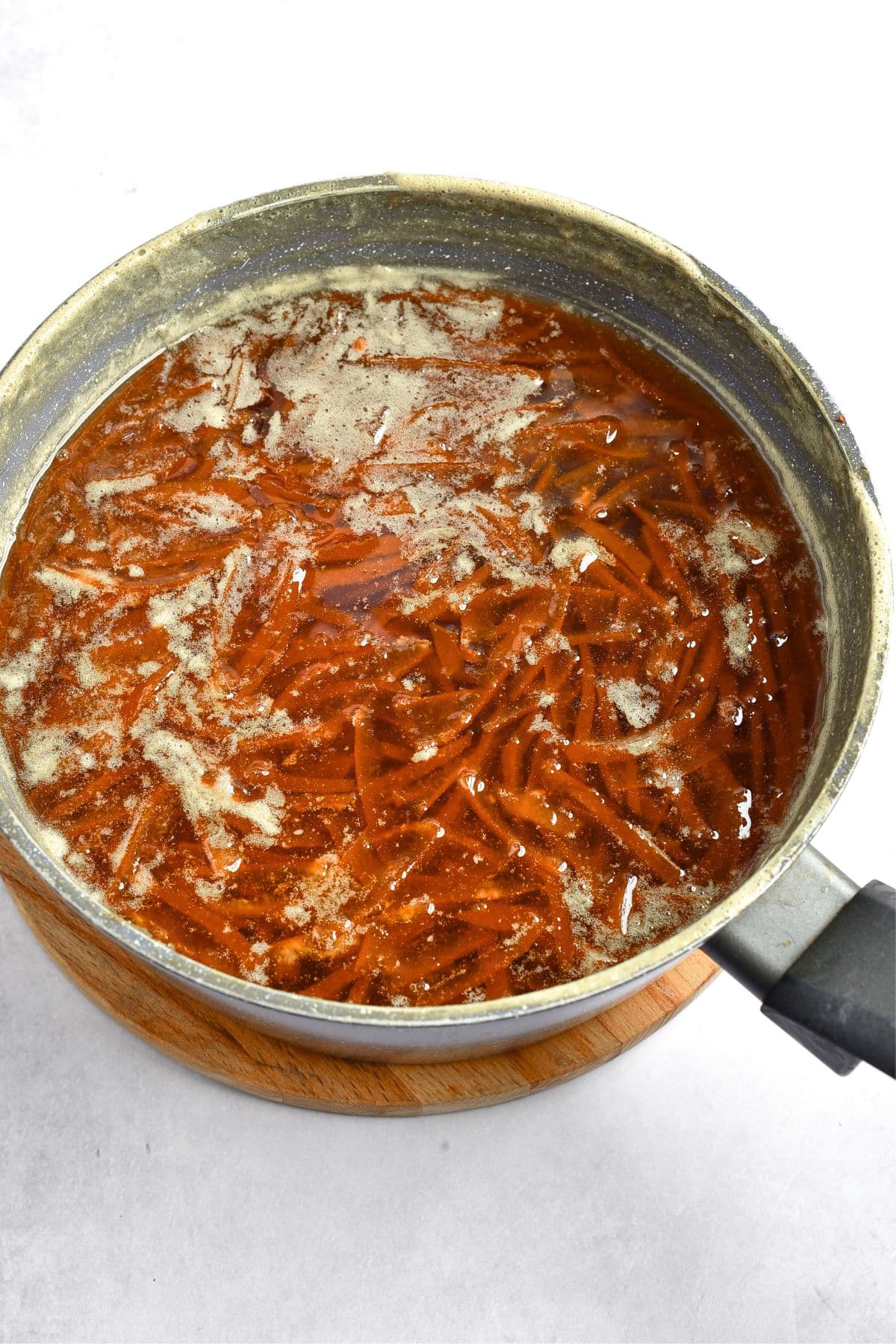 Cooking orange marmalade in pot