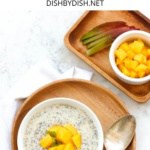 Mango chia pudding in white bowl topped with mangoes.