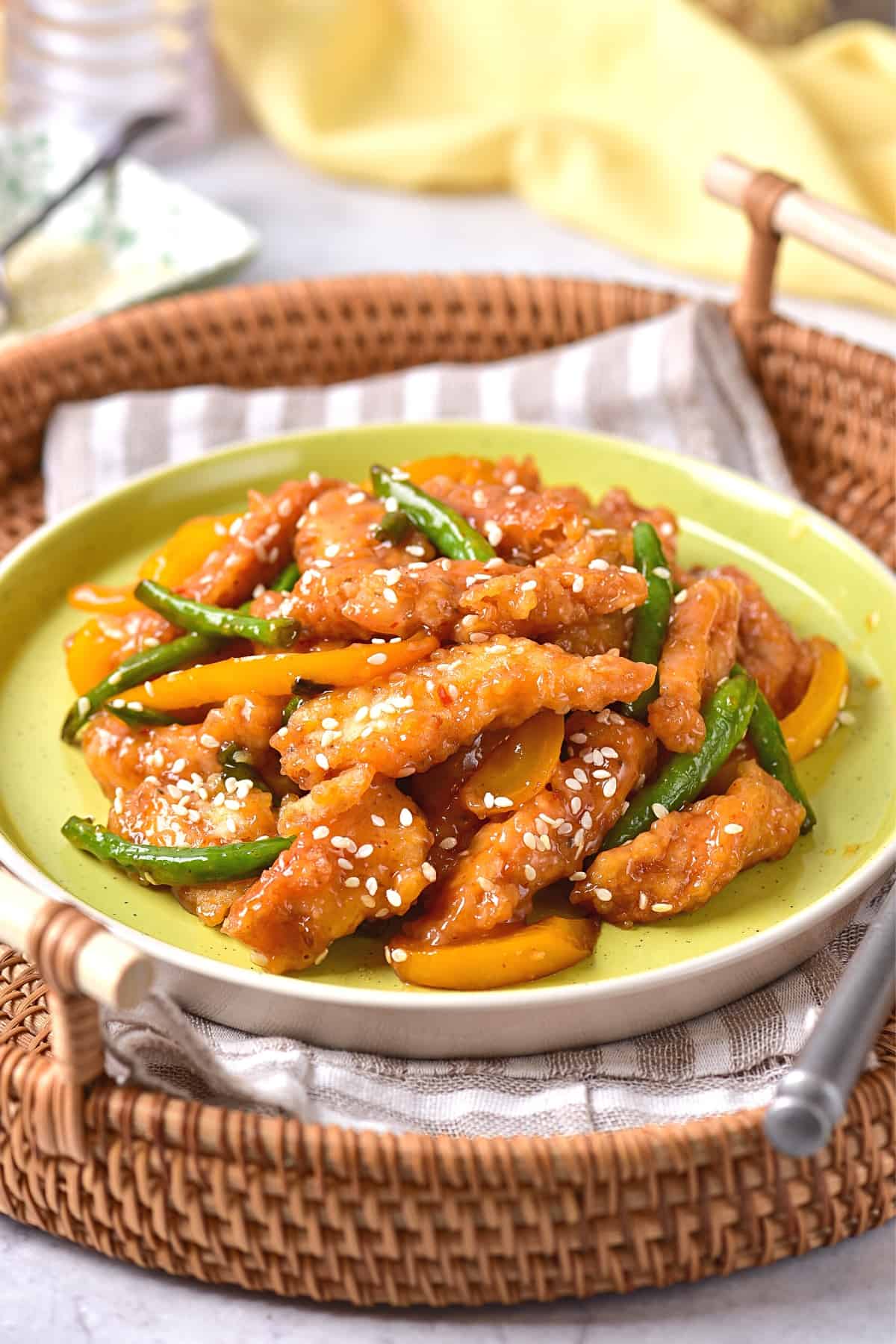 Honey sesame chicken on plate in a basket.