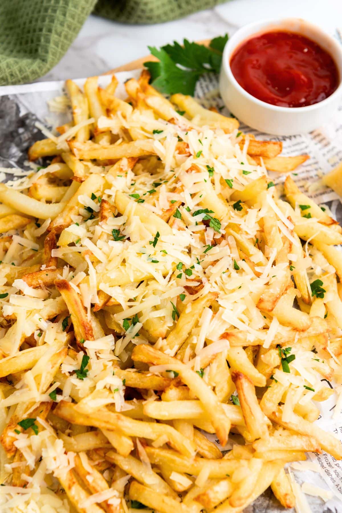 Fries topped with shredded parmesan and chopped parsley