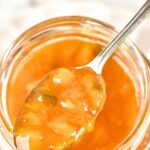 Holding a spoonful of peach and jalapeno jam