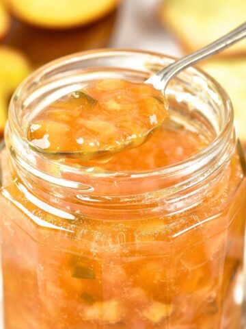 Holding up a spoonful of peach jalapeno jam