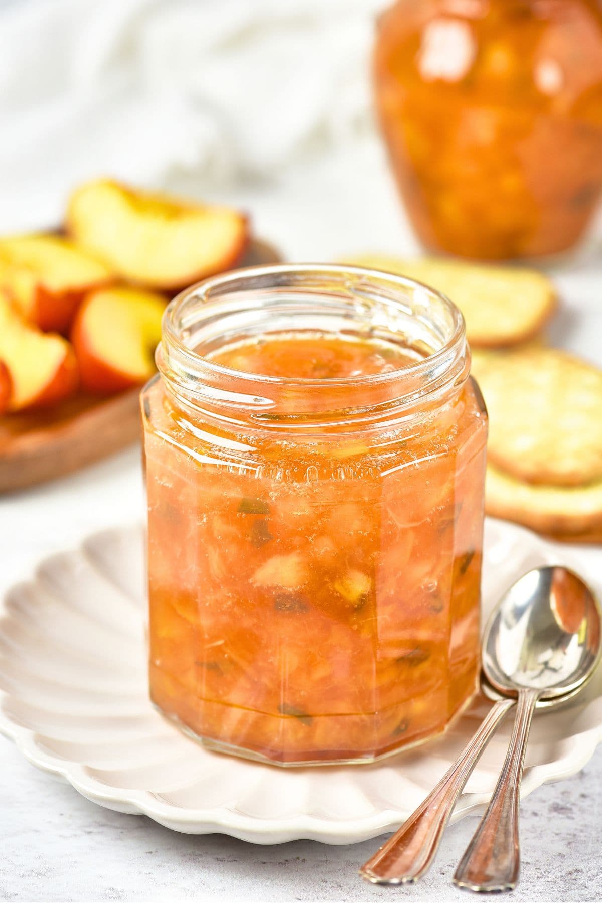 Peach Jalapeno Jam (Gluten-Free, Vegan) A jar of peach jalapeno jam on white plate