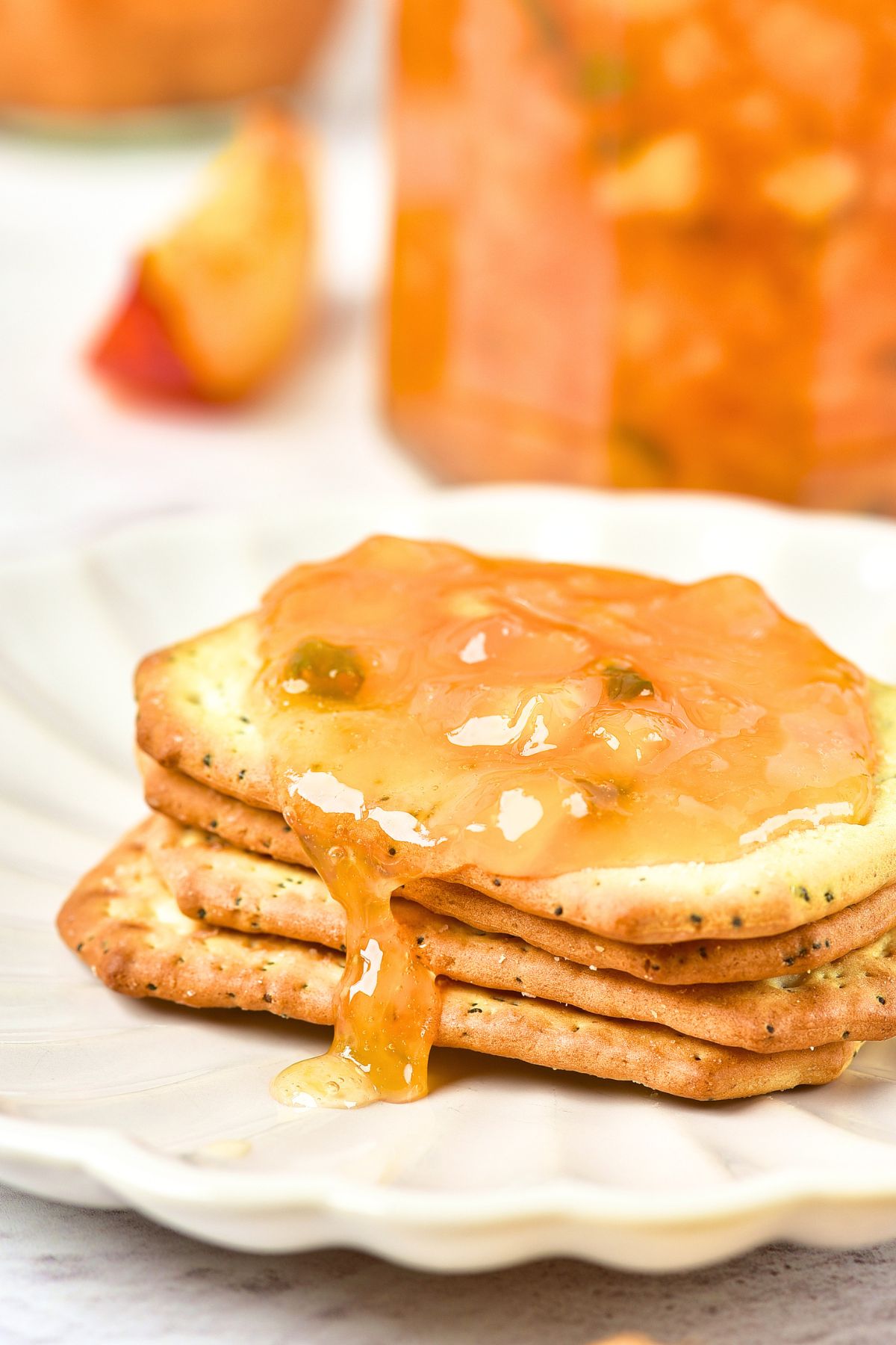 Hot Pepper Peach Jam A stack of crackers spread with peach jam