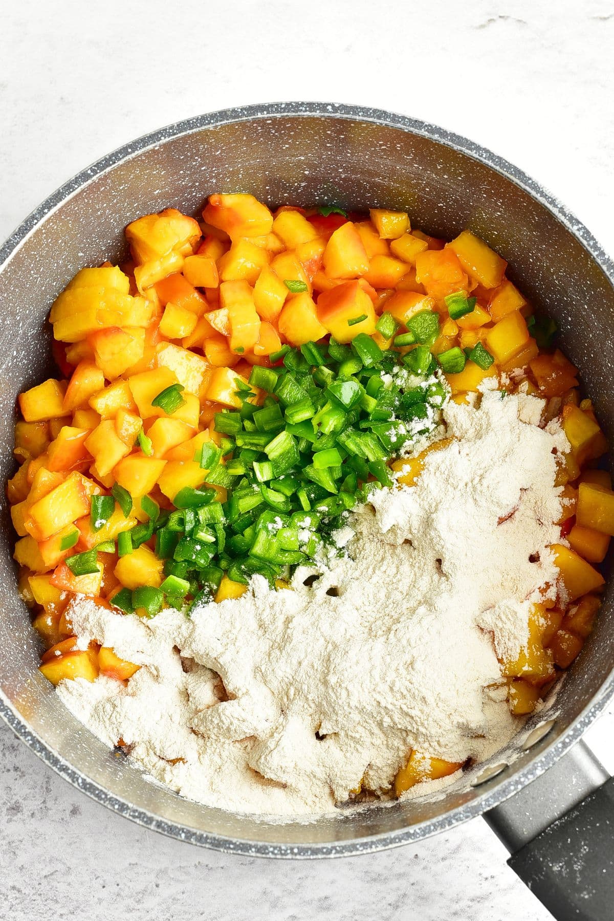 Jalapeno and Peach Jam Diced peaches and jalapenos and powdered pectin in a saucepan