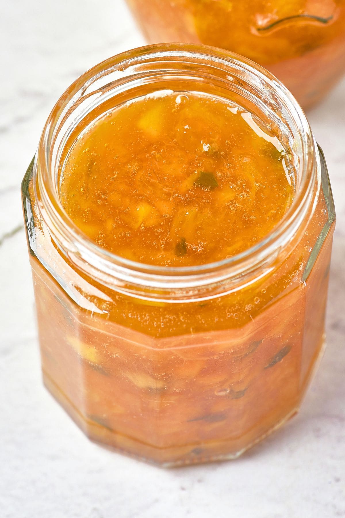 Peach and Jalapeño Jam Up close view of a jar of peach and jalapeño jam