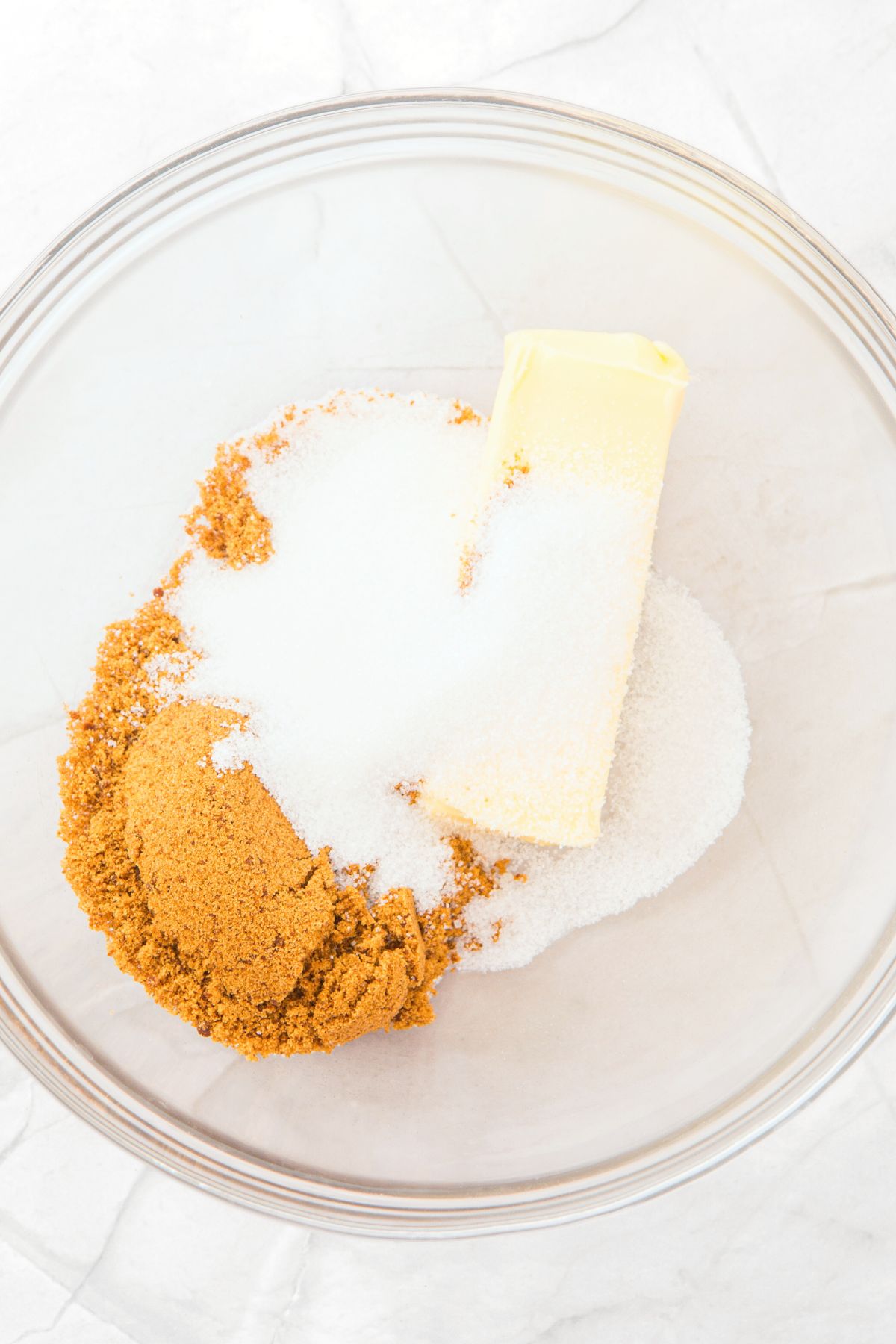 A bowl of butter, brown sugar and white sugar