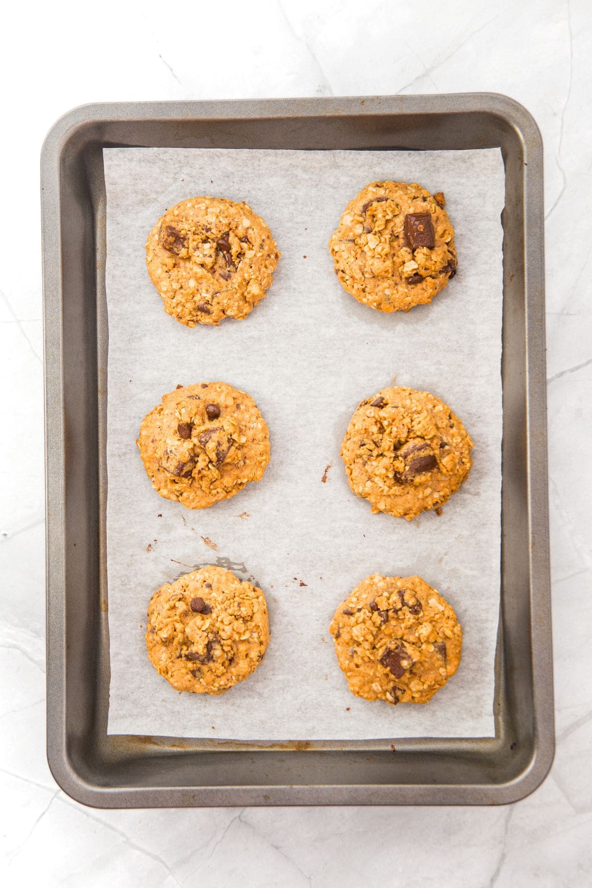Freshly baked cookies on parchment-lined baking sheet