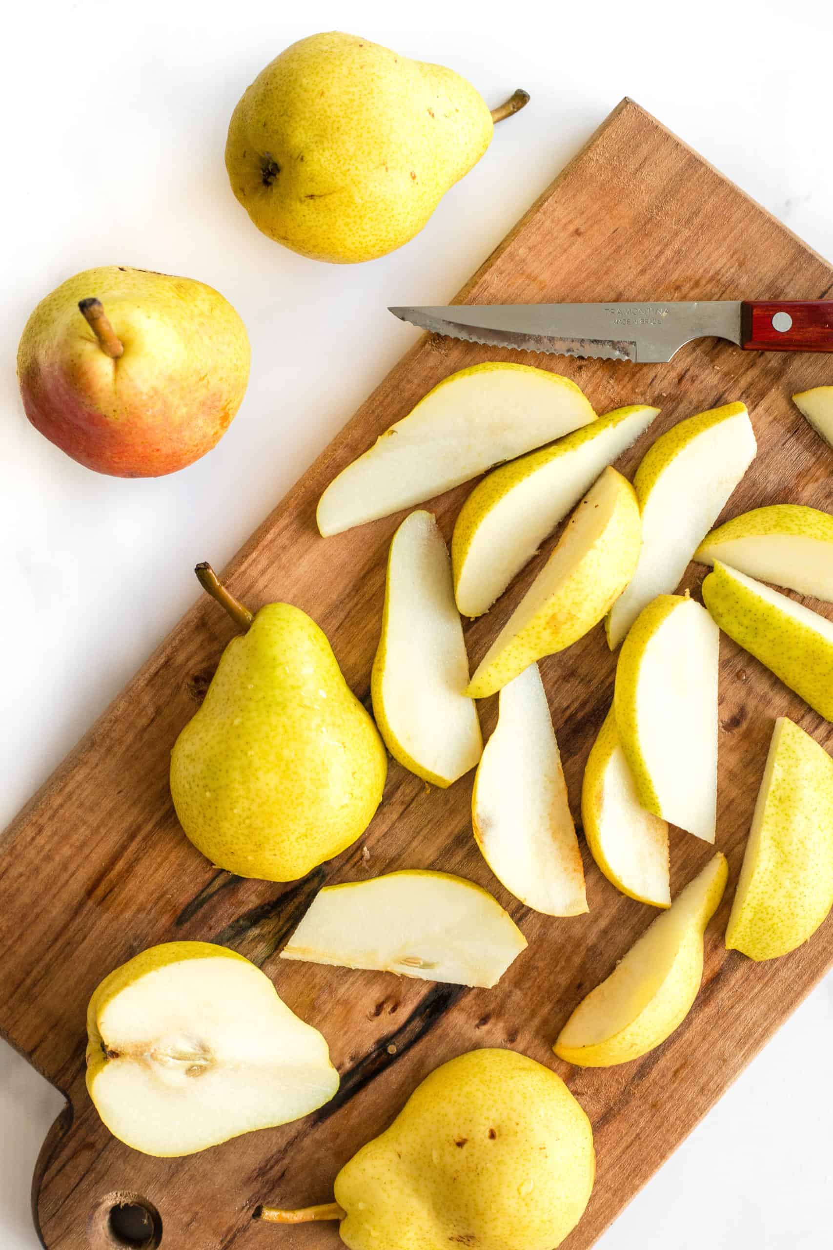 Pears sliced on a wooden board
