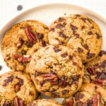 Top down view of a platter of chocolate chip pecan cookies