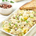 Pineapple chicken salad sprinkled with parsley on plate.
